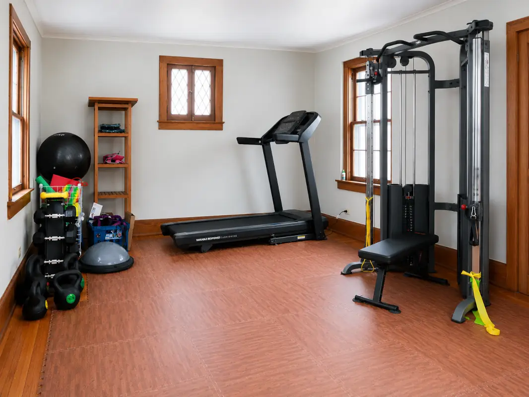 Our modern and private rehabilitation equipment room - weight machine, treadmill, weights, exercise balls and more